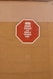 A red octagonal sign mounted on a tan-colored wall with the text 'KEEP CALM AND RENT A WICKED VAN' in white letters along with a white icon of a van at the top.