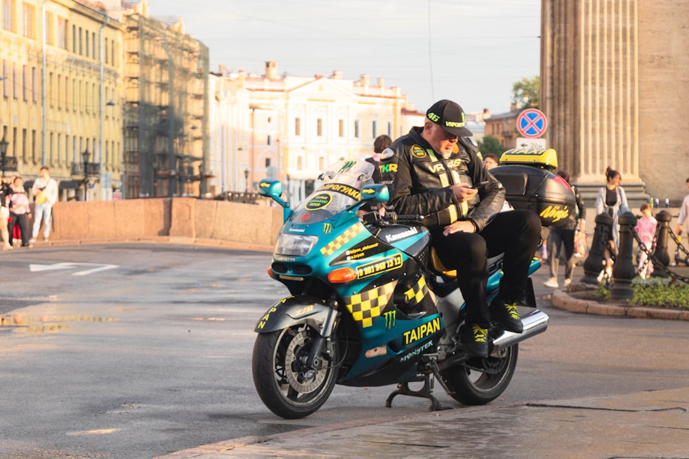 a man riding on the back of a motorcycle down a street