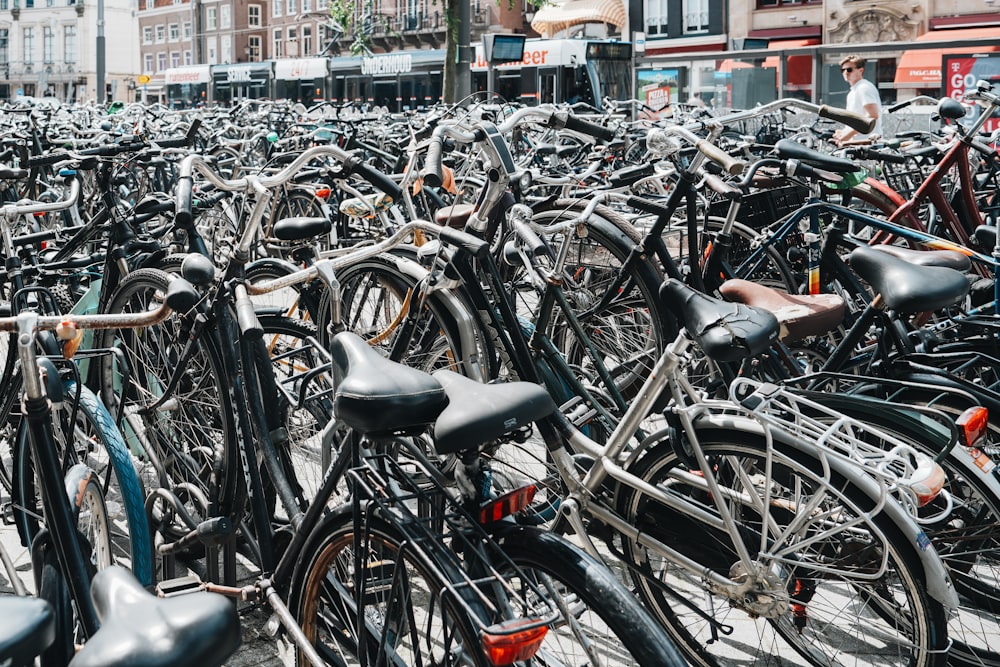 a large group of bicycles parked in a parking lot
