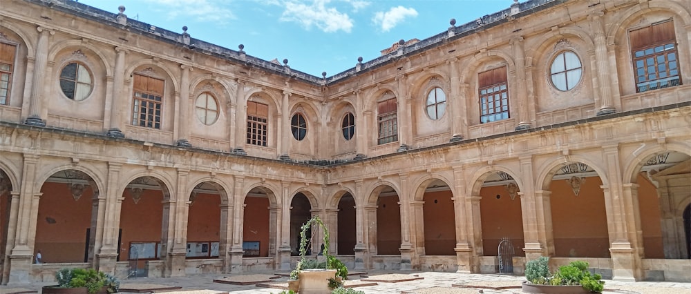 the courtyard of a large building with many windows