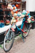 a bicycle with a bunch of balls on the back of it