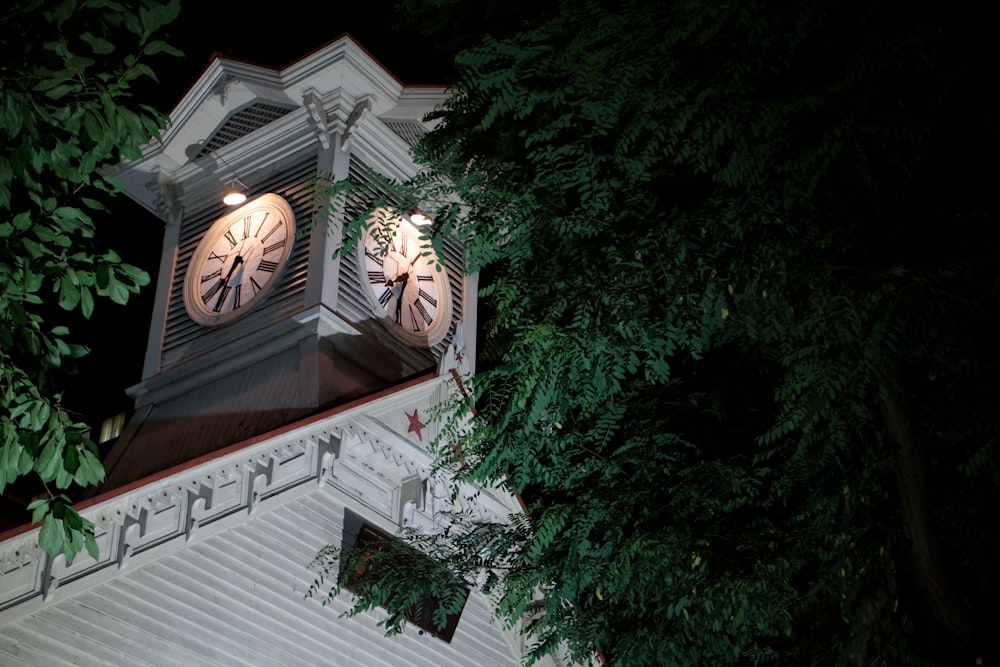 a clock tower with two clocks on each of it's sides