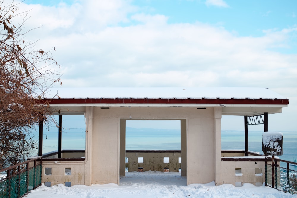 a white building sitting on top of a snow covered slope