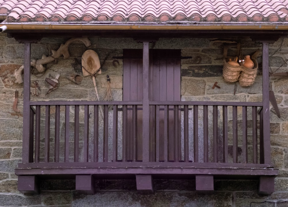a purple wooden balcony with pots and pans on it