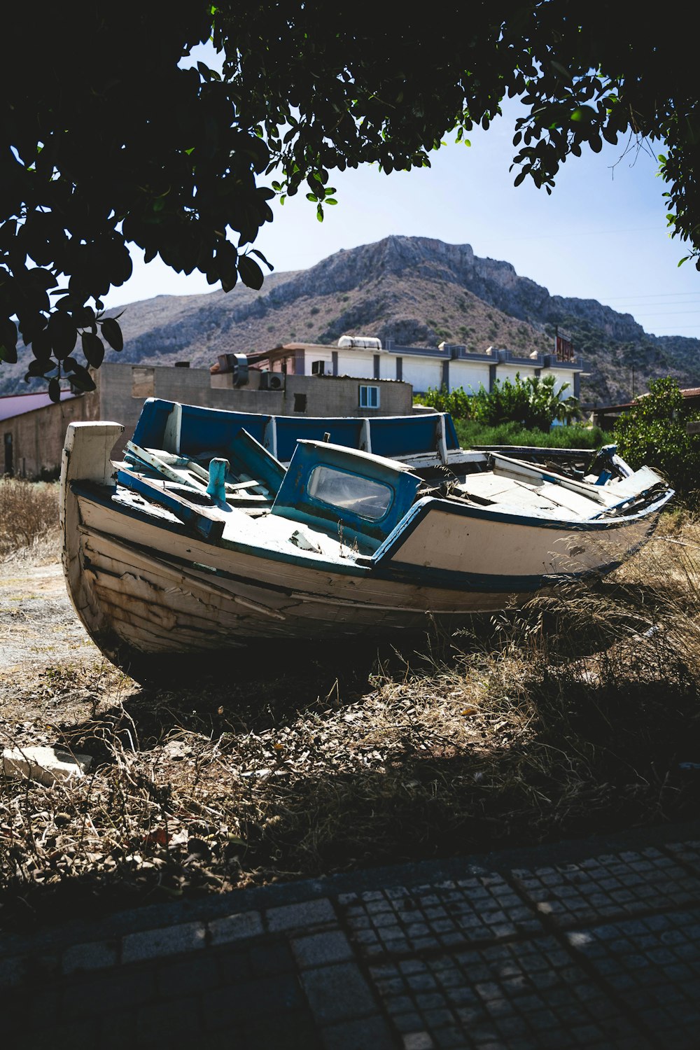 a boat sitting on top of a dry grass field