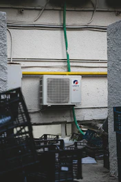 A customer handing over a used split AC unit to a friendly buyer in Delhi NCR.