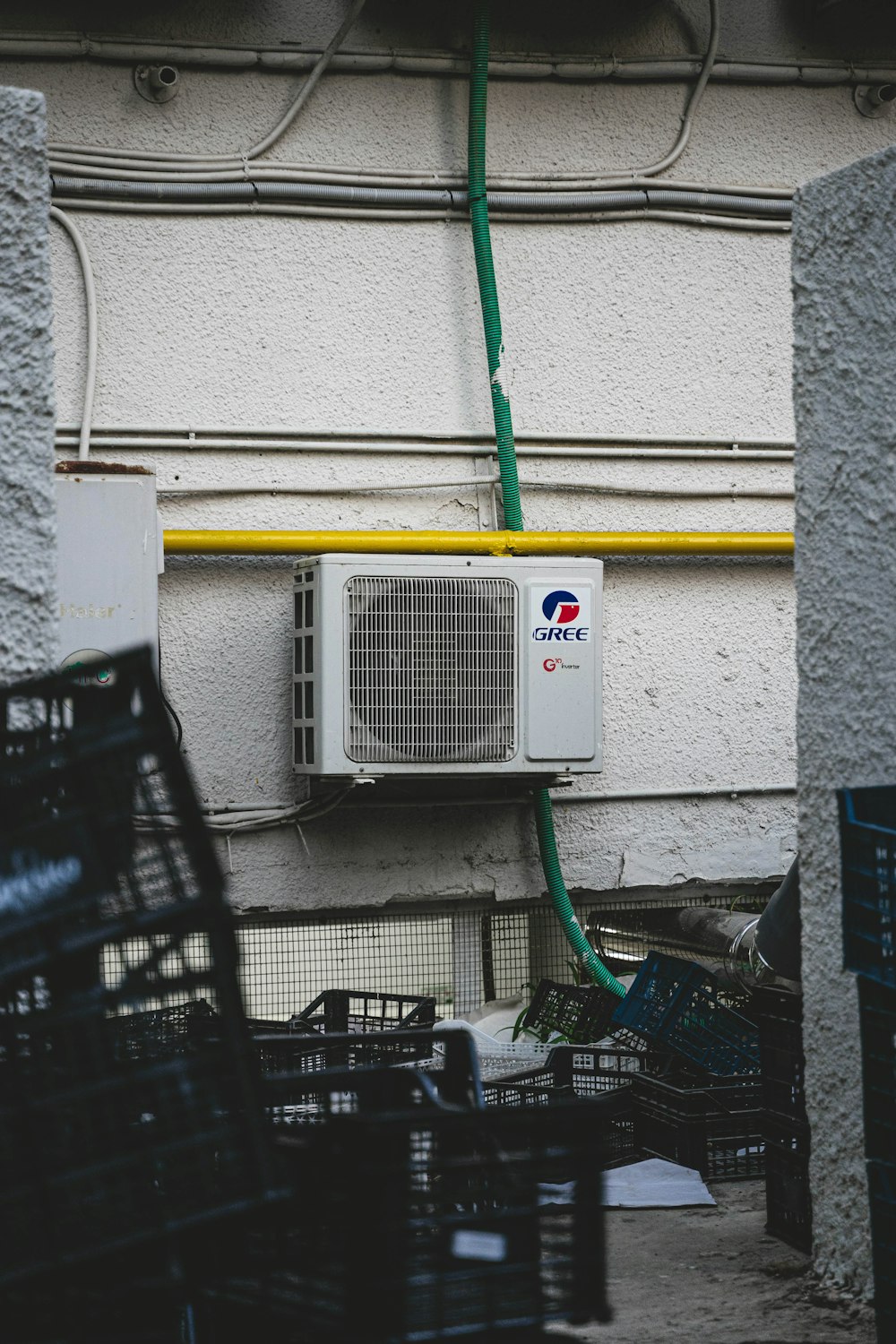 a white air conditioner sitting on the side of a building