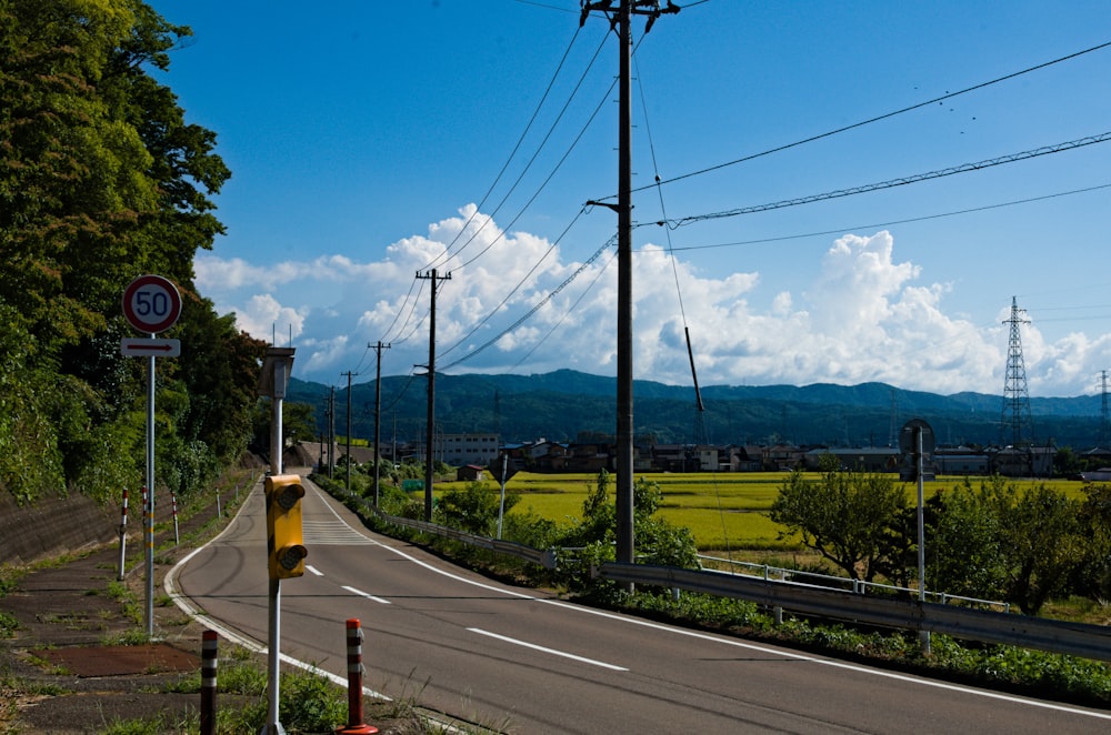 an empty road with power lines above it