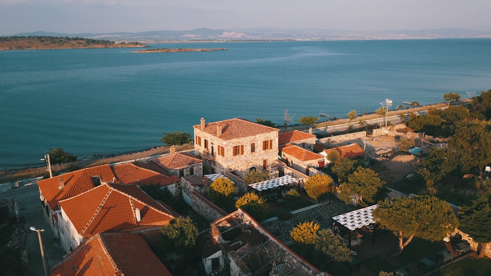 an aerial view of a building and a body of water