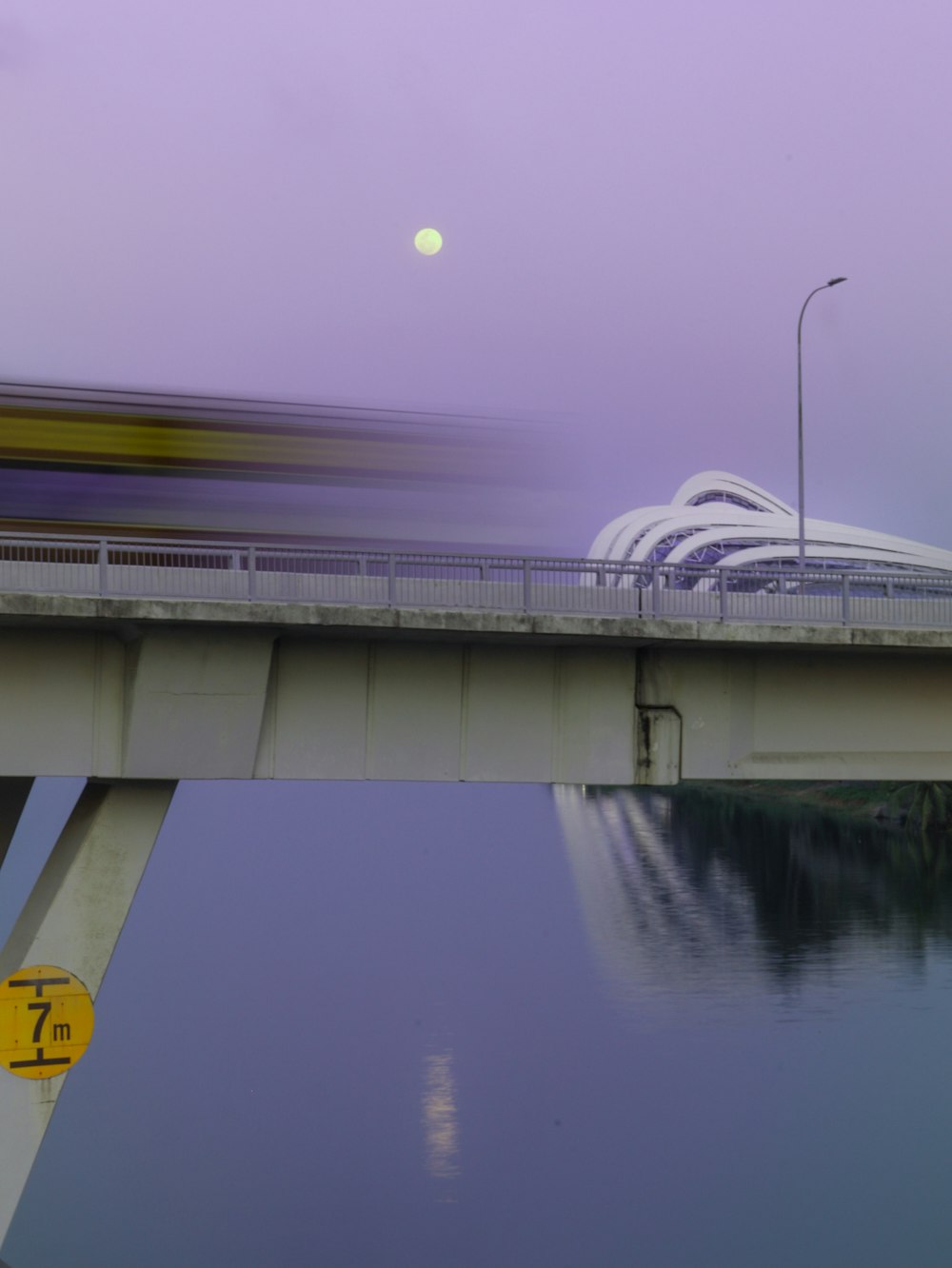 a train traveling over a bridge over a body of water