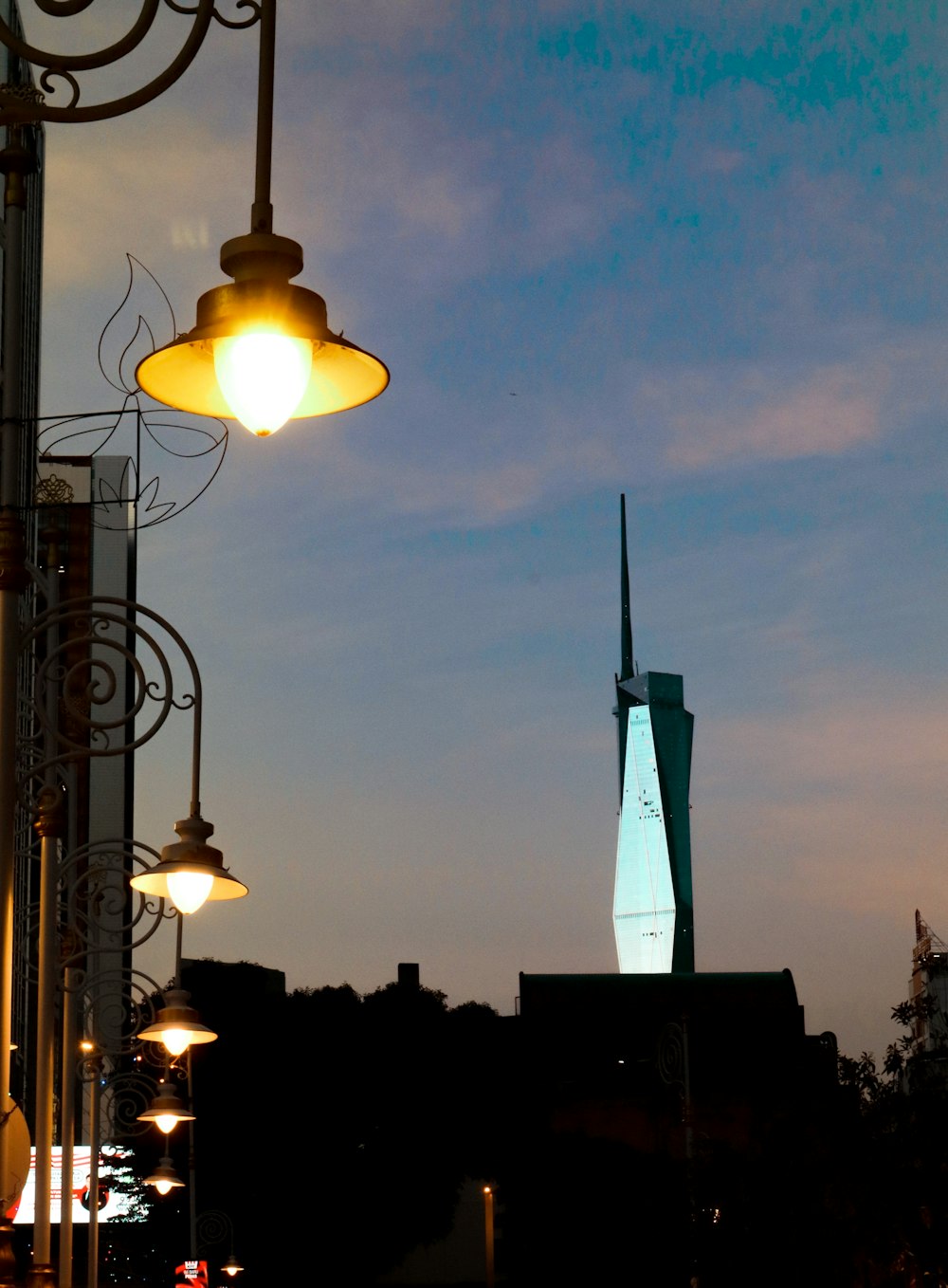 a street light with a building in the background