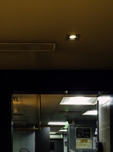 A friendly instructor assisting a student with HVAC equipment in a bright training room.