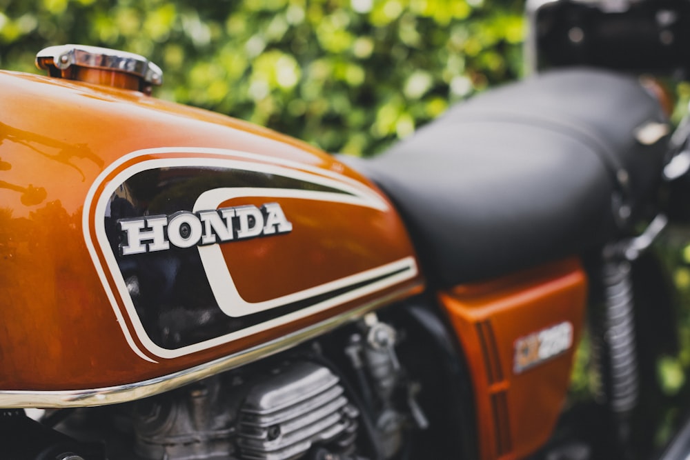 a close up of a motorcycle parked in front of a bush