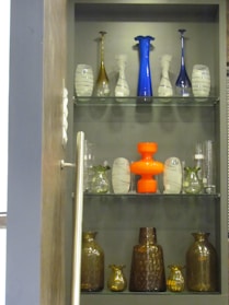 An assortment of elegant glass vases on a shelf.
