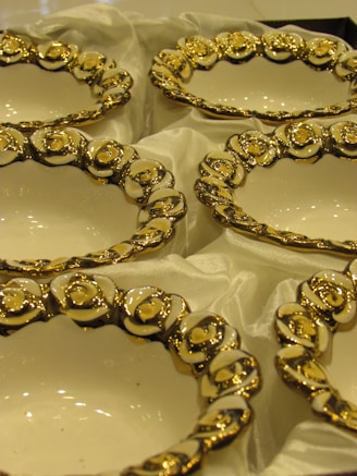 Close-up of delicate ceramic bowls with intricate floral patterns and glossy finish.
