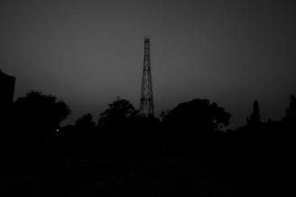 An old radio tower silhouetted against a twilight sky.