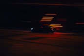 Dynamic shot of a cinematic car chase with blurred lights and intense motion.