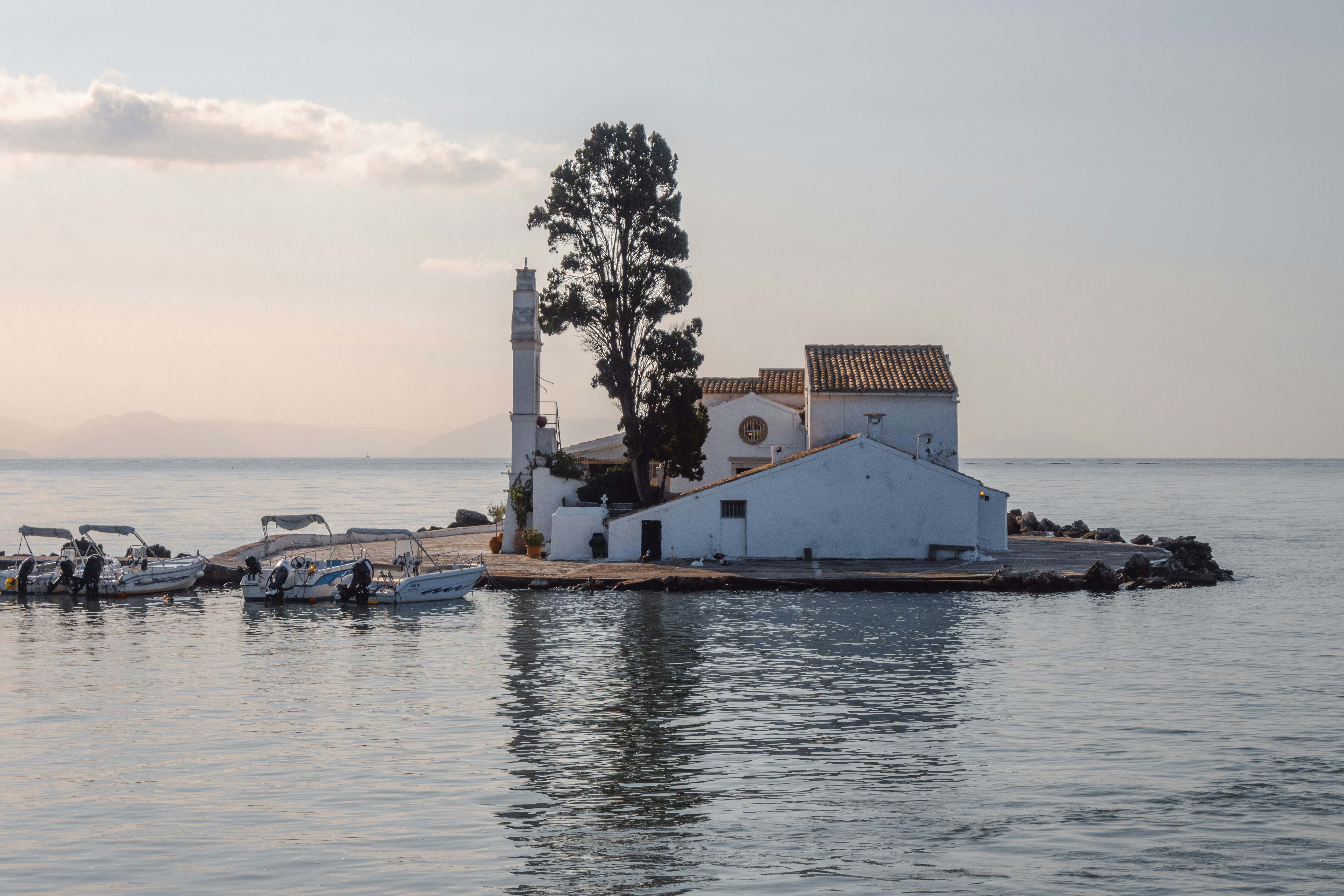 a white building sitting on top of a body of water