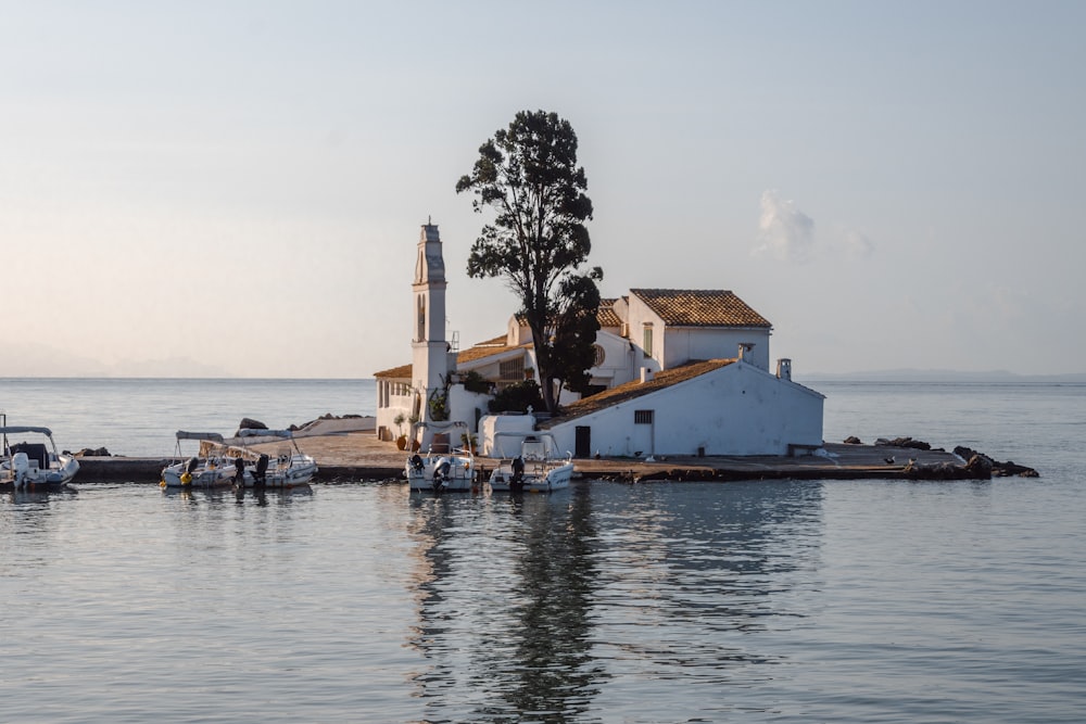 a small white house sitting on top of a pier