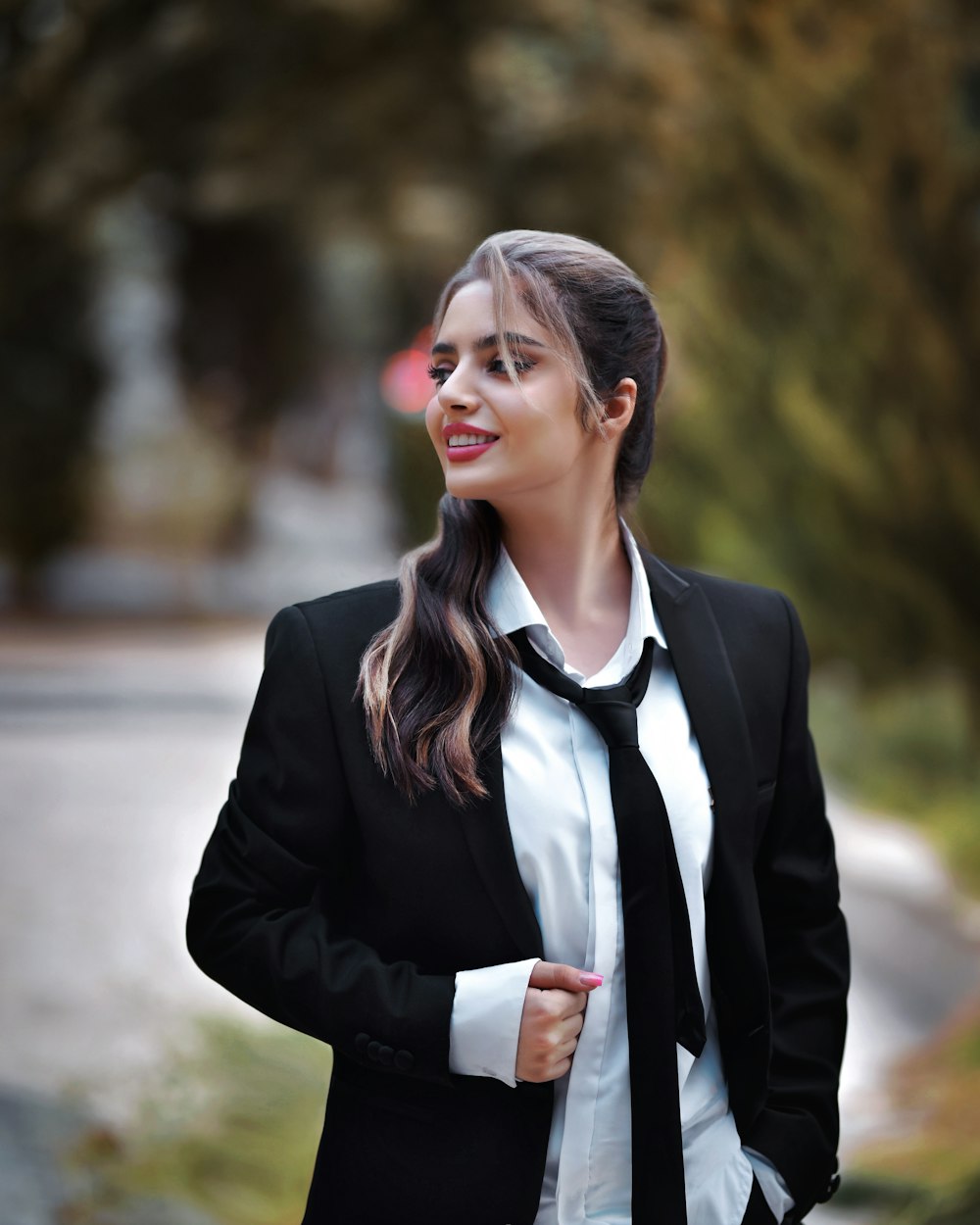 a woman wearing a black tie and a white shirt