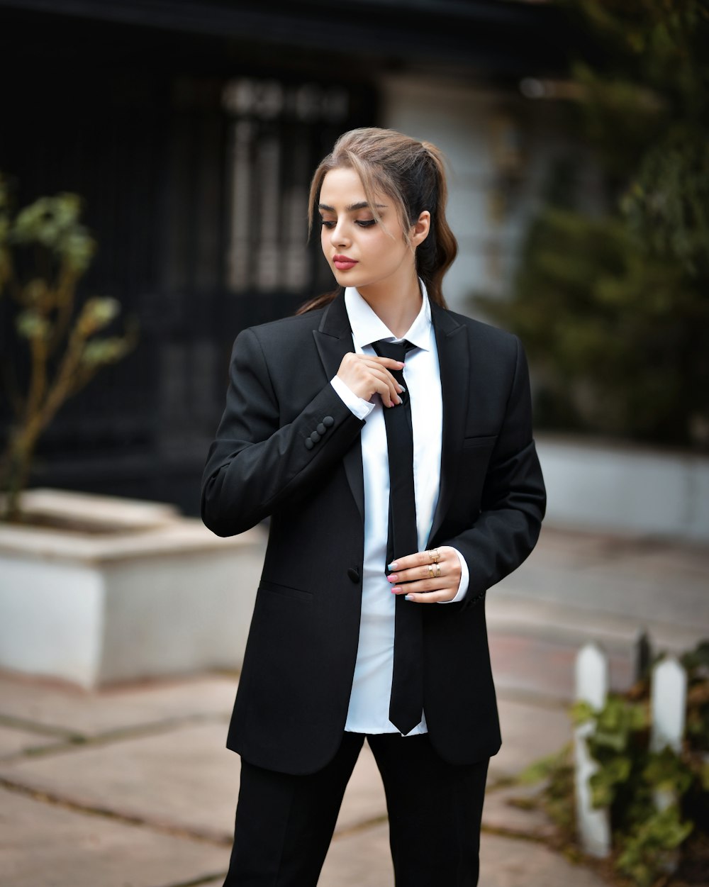 a woman in a black suit and white shirt