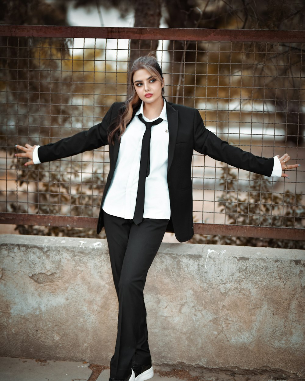 a woman in a suit and tie posing for a picture