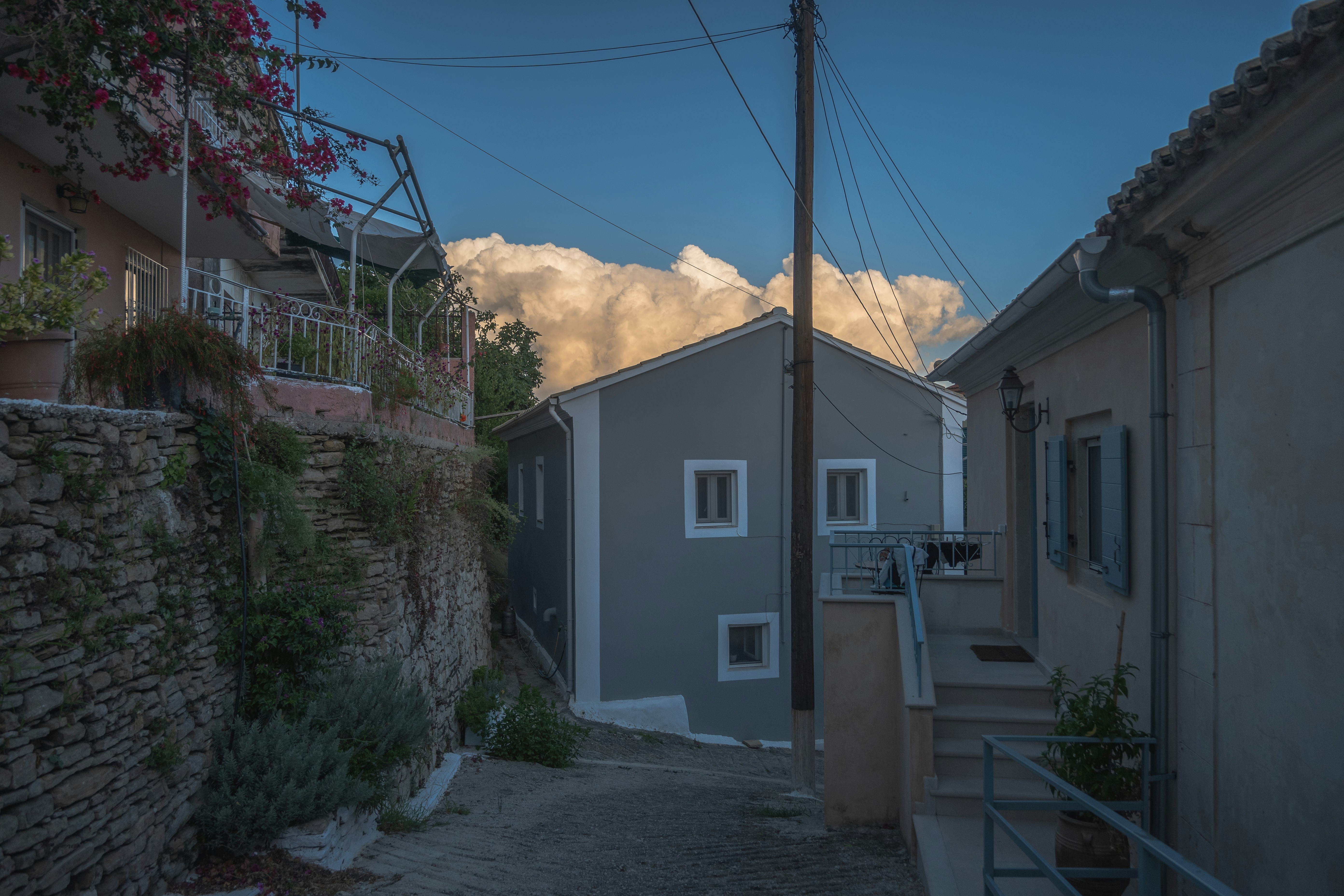 a street with a house and a mountain in the background, 