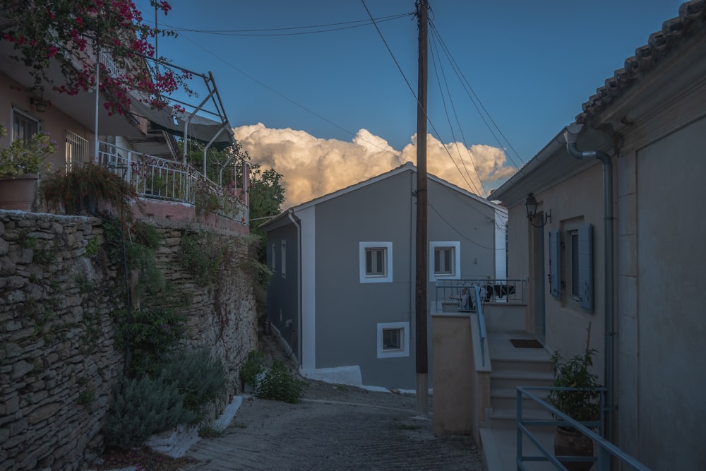 a street with a house and a mountain in the background