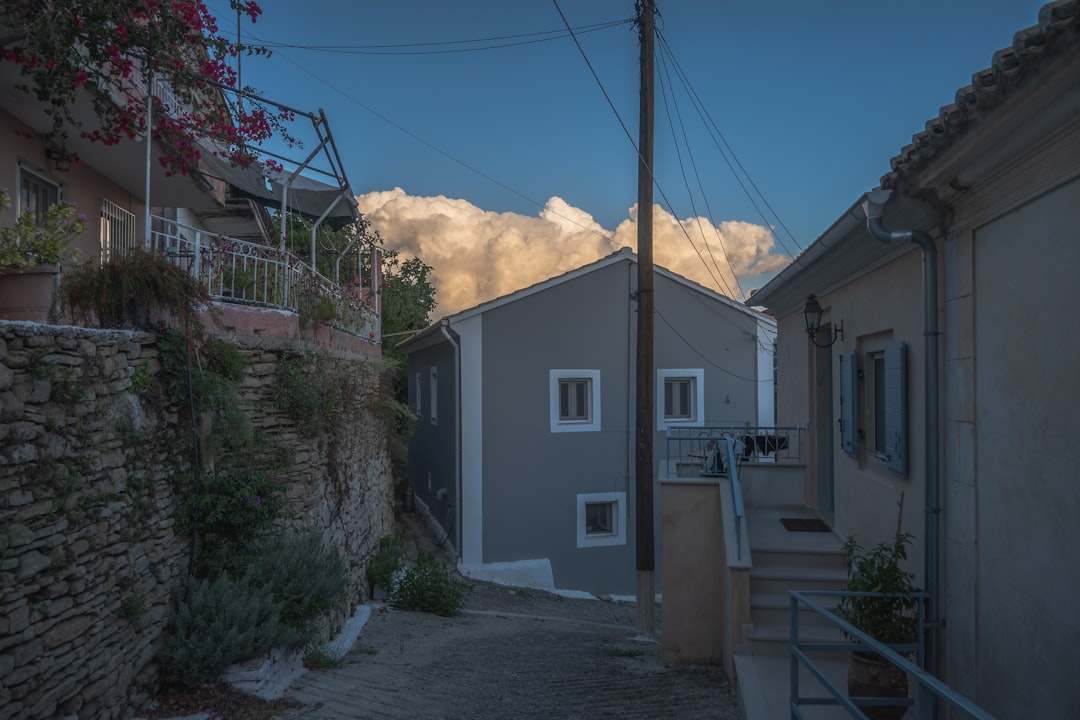 a street with a house and a mountain in the background,