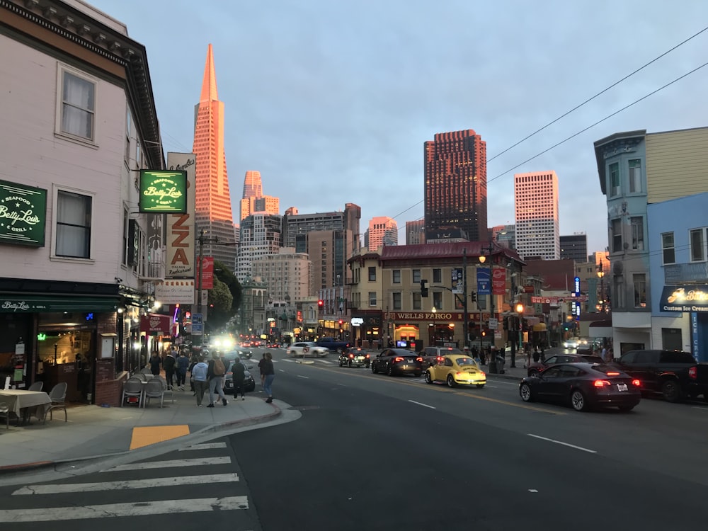 a city street filled with lots of traffic and tall buildings