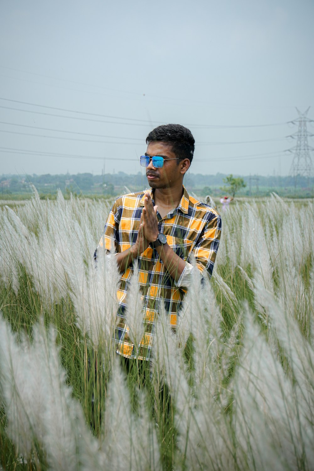 a man standing in a field of tall grass