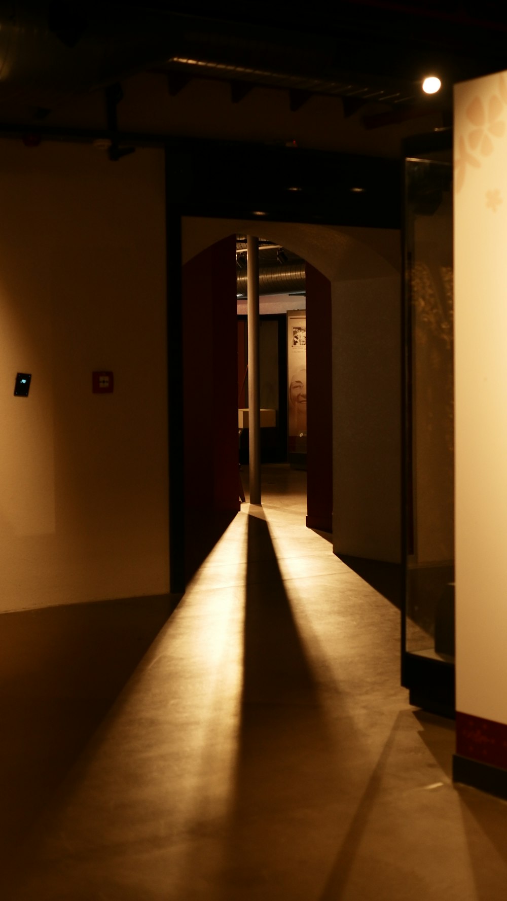 a long hallway with a light shining down on it