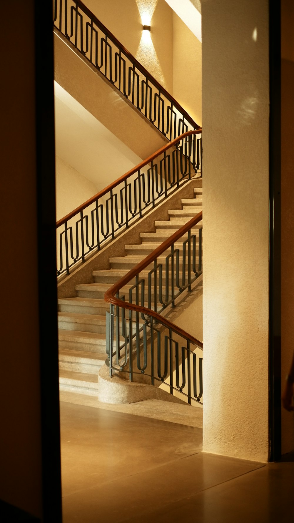 a view of a staircase through a glass door