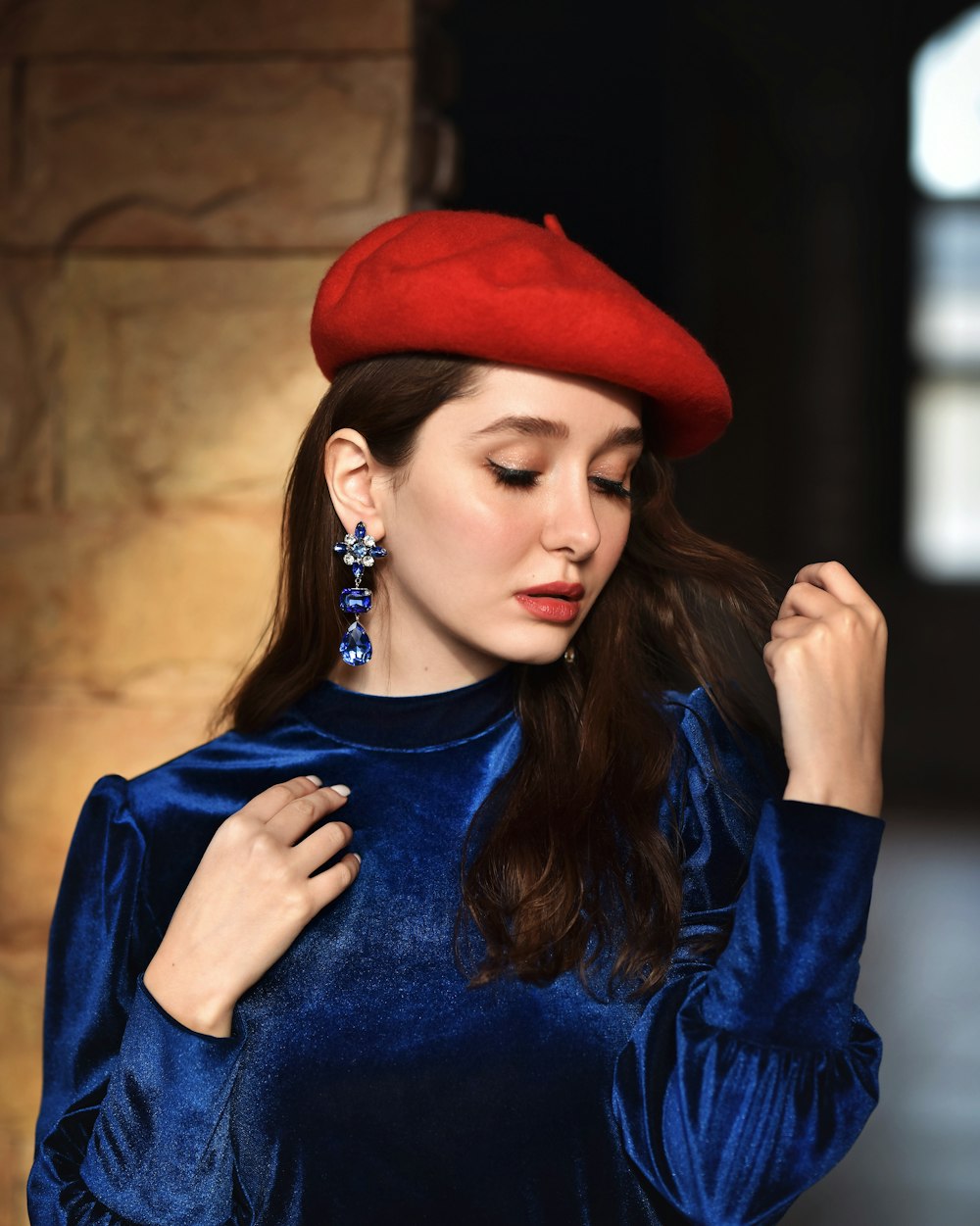 a woman in a blue dress and a red hat