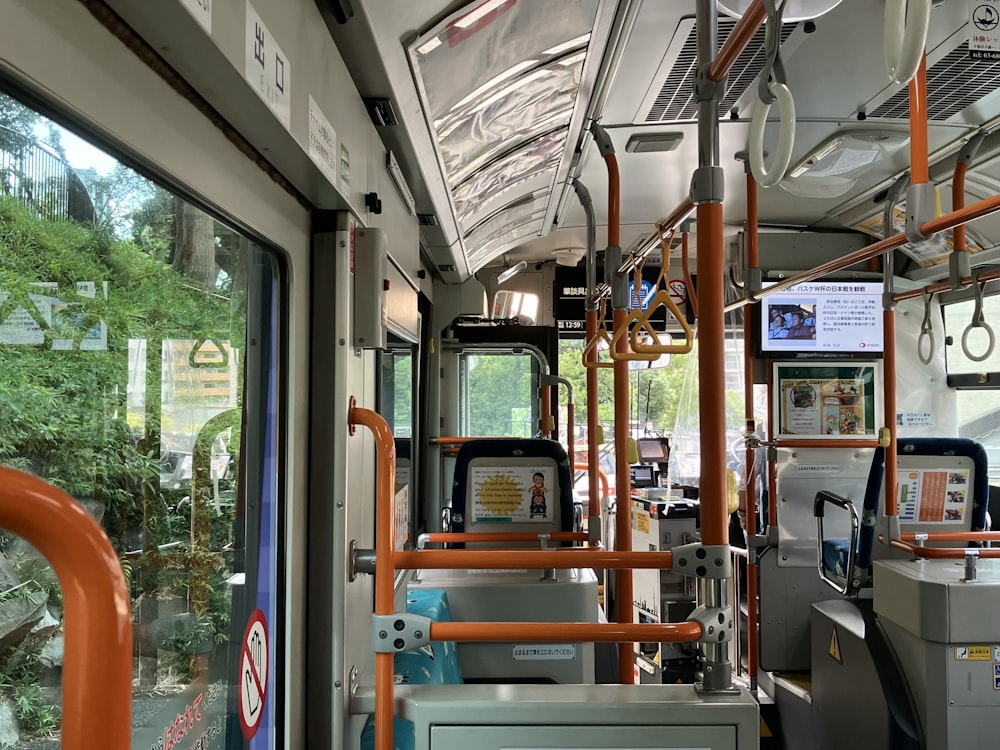 the inside of a public transit bus with lots of windows