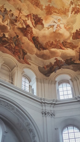 A large mural of a sky painted by Gaetano Siniscalchi inside a church.
