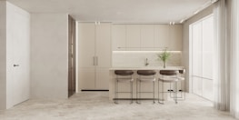 A modern kitchen layout with an island and seating.