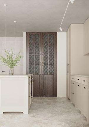 Elegant kitchen design with minimalist style and a blend of white and beige finishes.