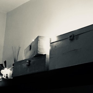 A bright, inviting photo of various stylish storage boxes neatly arranged in a modern living room.