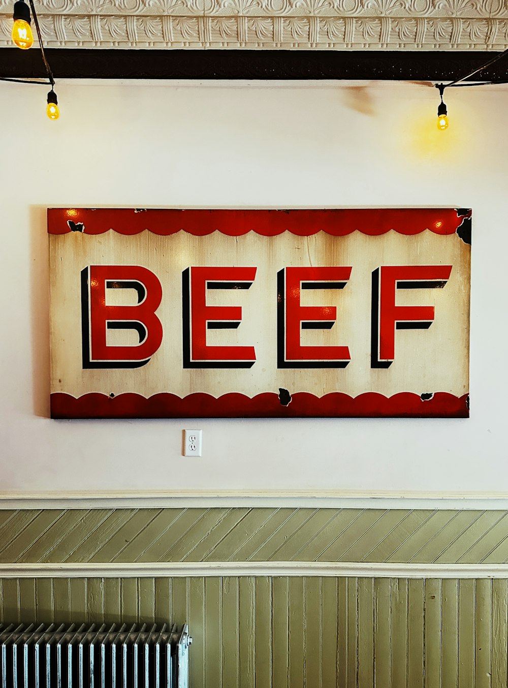 a sign that reads beef hangs on the wall
