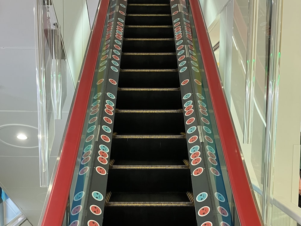 an escalator in a building with a painted design on it
