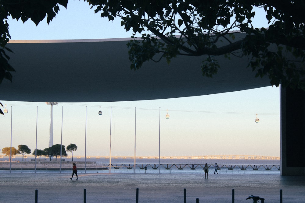 a group of people walking on a beach next to the ocean