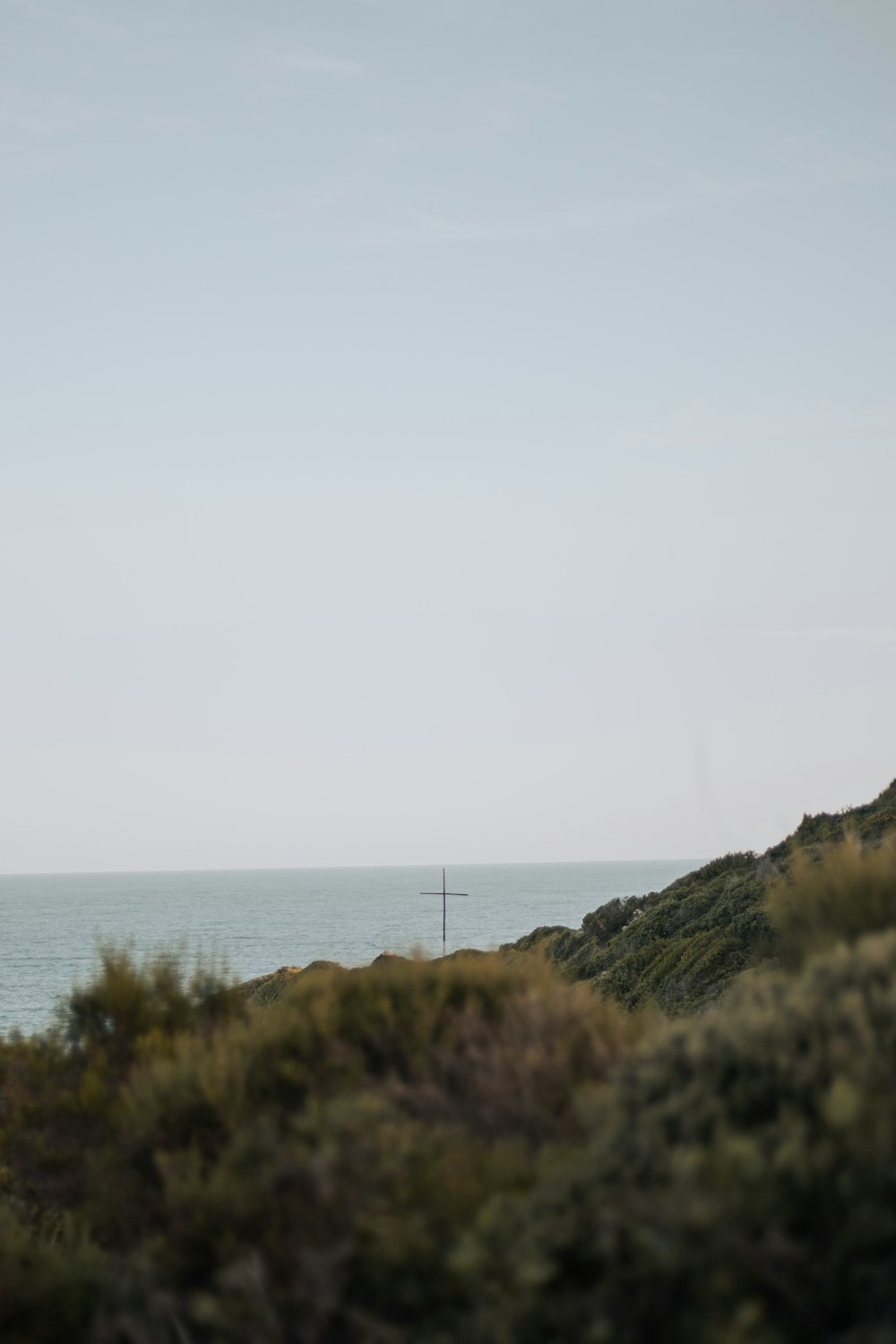 a lighthouse on a hill overlooking the ocean