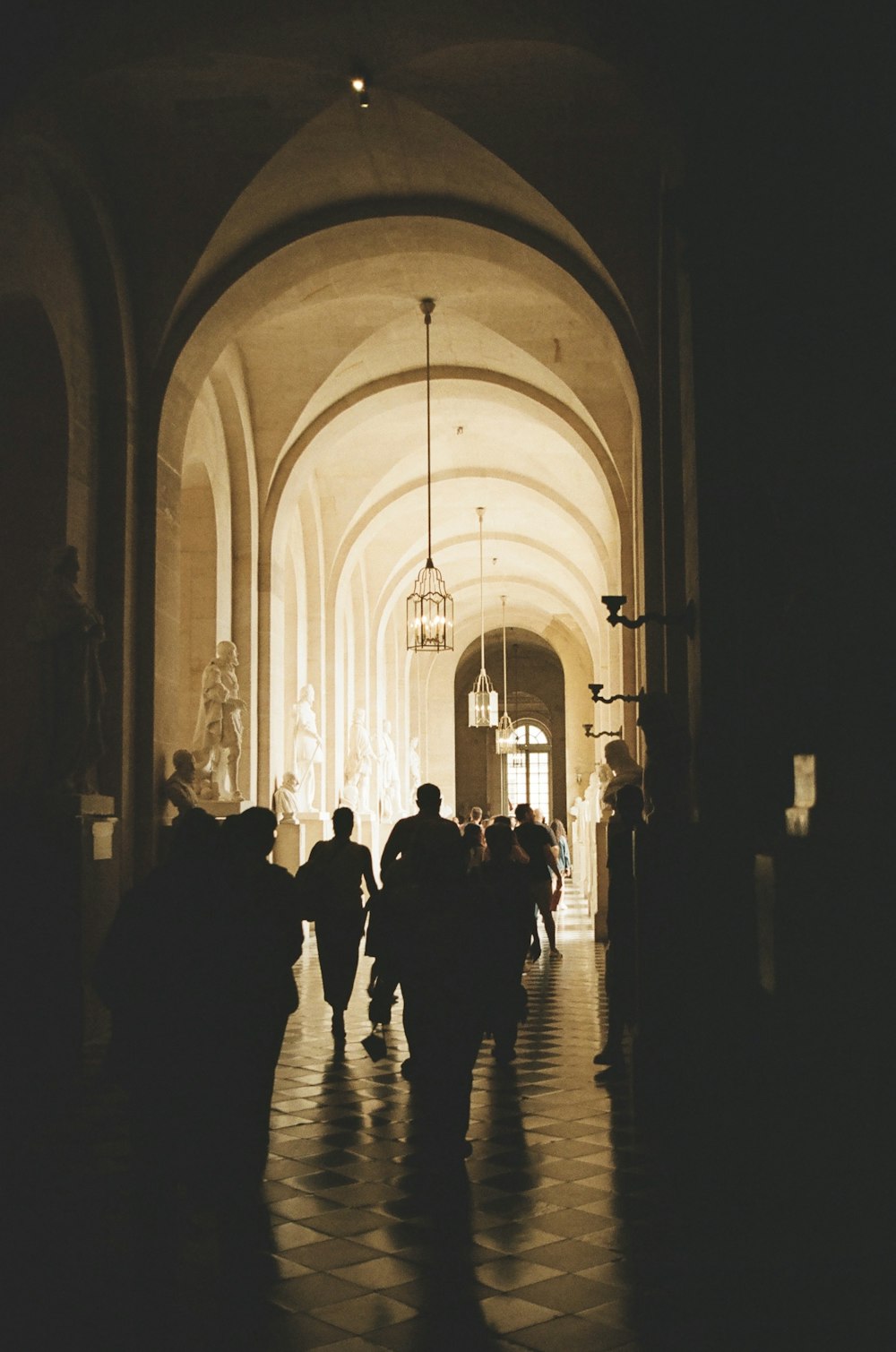 a group of people walking down a hallway