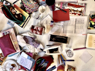 A pile of quirky lifestyle products spilling over a colorful table.