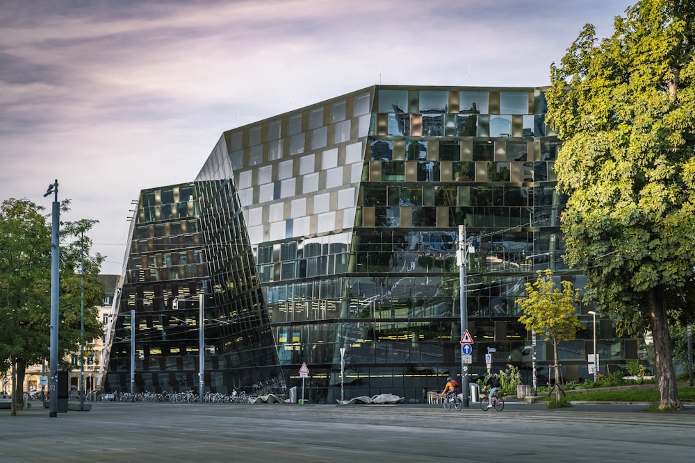 a large glass building sitting next to a street