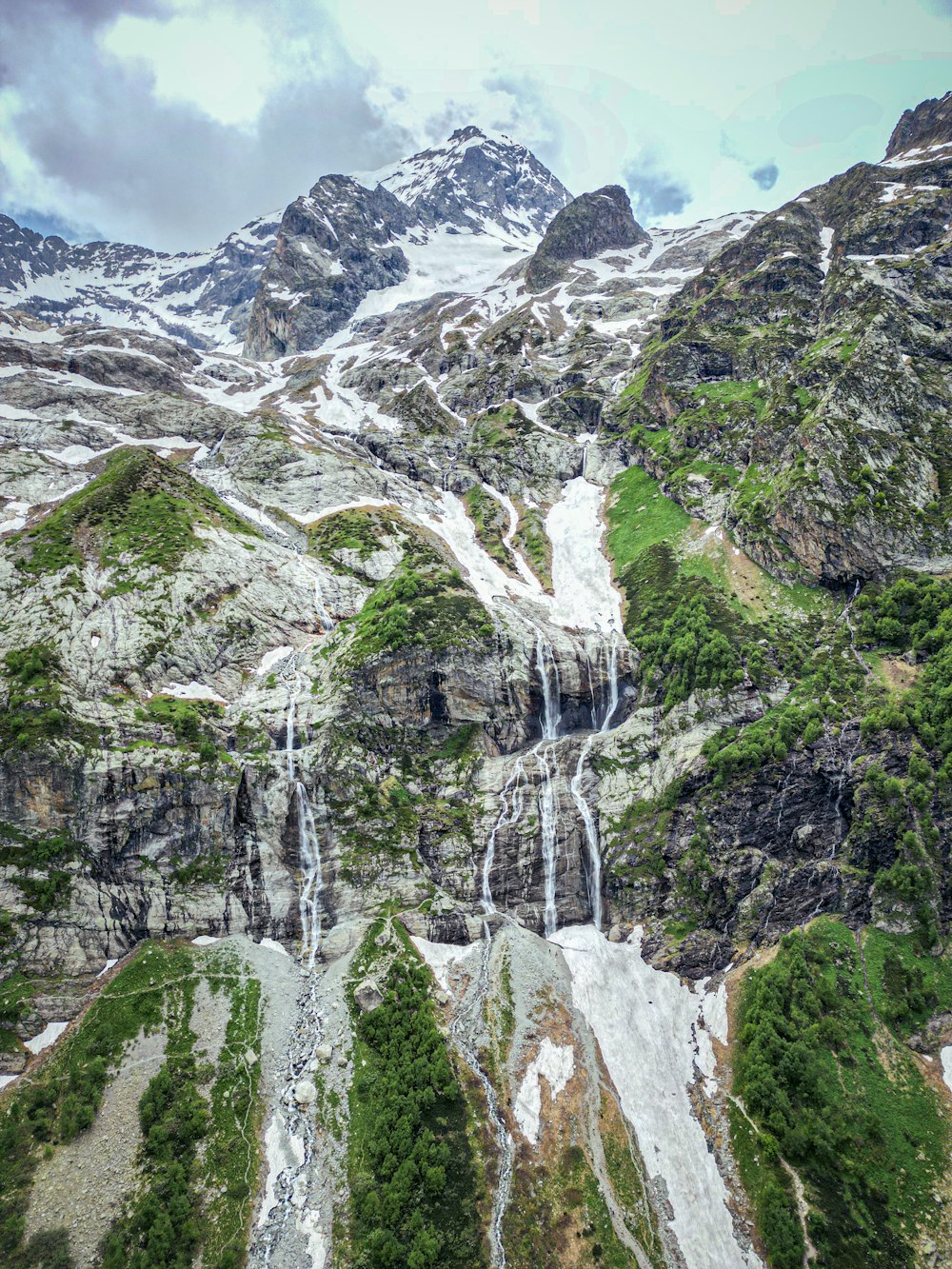 a mountain with a waterfall in the middle of it