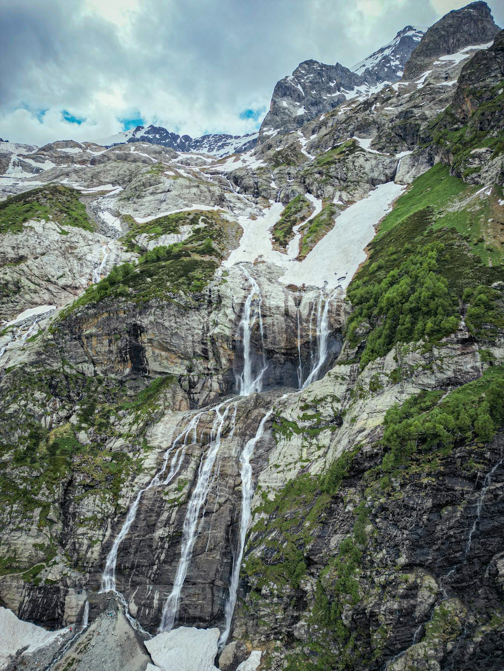 a waterfall in the middle of a mountain range