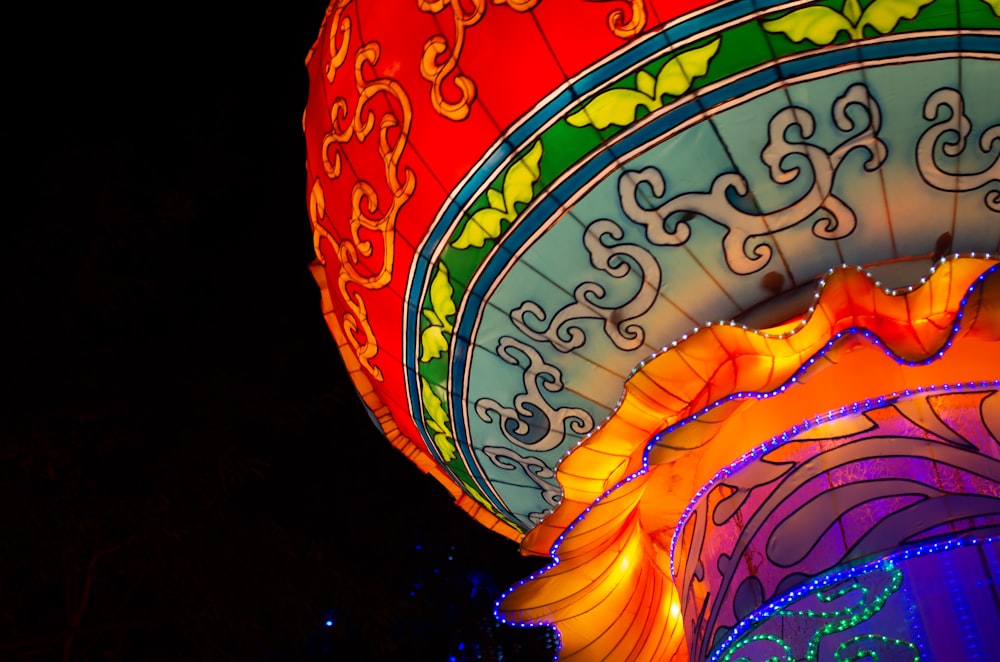 a brightly lit oriental lantern in the dark