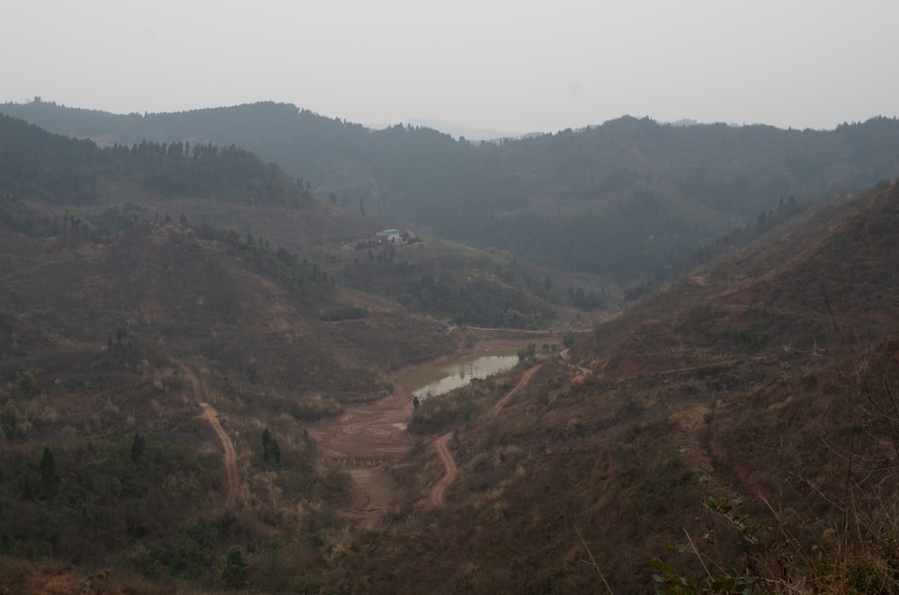 a view of a valley with a lake in the middle of it